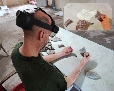 HKU Faculty of Arts Professor Peter J. Cobb compares the 3D model of a virtual pottery sherd with an adjoining real sherd. The small photo is what he sees in the MR headset. (Photo credit: HKU Faculty of Arts)